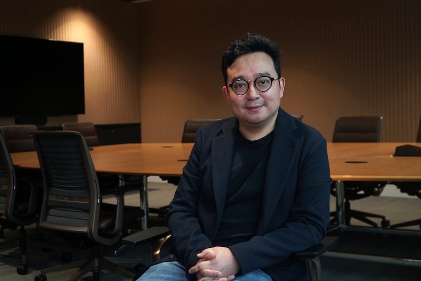 a man in suit look at the camera